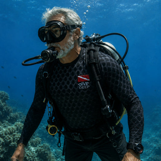 Scuba diver over a coral reef wearing a long-sleeve black rash guard